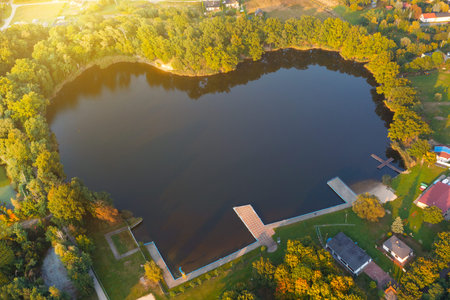 Aerial view of the lake among the trees in the shape of a heart in the village of Dolny Brzeg, Polandの写真素材
