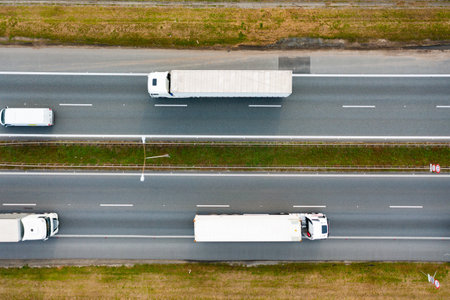 the movement of trucks on the freeway. Aerial photographyの写真素材