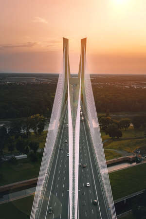 Large bridge with pylons against the backdrop of the setting sun. Redzinski Bridge, Wroclaw Polandの写真素材