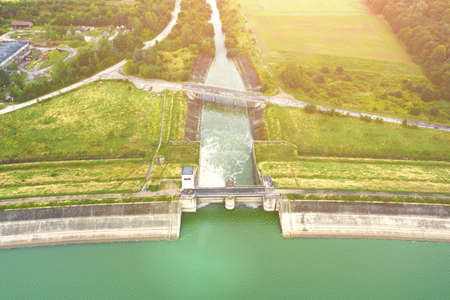 Aerial view of a large dam with a strong stream of water on the lake, in the city of Metkow Polandの写真素材
