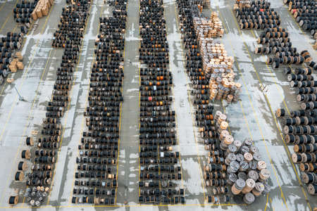 Top view of large number of wooden spools of powerful black telecommunication wireの写真素材
