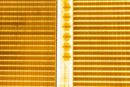 many greenhouses for growing tomatoes and cucumbers, a building with a luminous roof, vegetable growingの写真素材