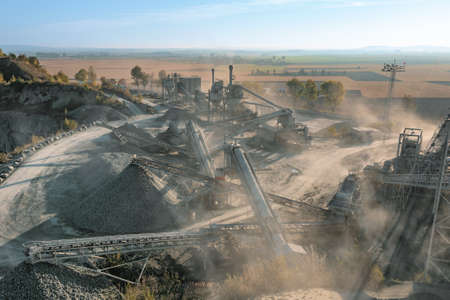 Granite quarry against a background of blue sky, large piles of stone and huge deposits of granite in the rocksの写真素材