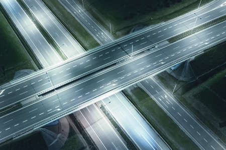 transport junctions and bridges at night, motorways at nightの写真素材