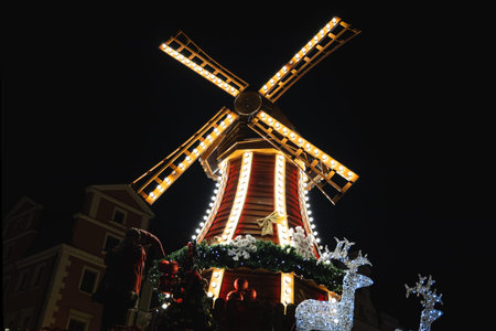 Wooden mill at the Christmas market, brightly lit by many lanternsの写真素材