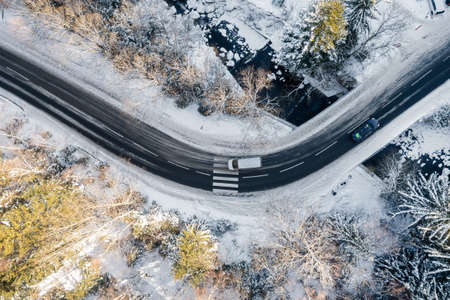 Landscape. A view from a height on a winter road in a snowy forest.の写真素材