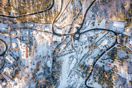 Winter landscape from the air, many winding mountain roads. Winter forest from above and Karpacz village in Poland. Winter recreation centerの写真素材