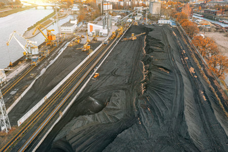 Large piles of coal, top view. Coal storage at the TPP, unloading and loading of coal by excavators...