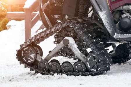 Caterpillar of a sport snowmobile closeup. Detailed view of the rear of the SUVの写真素材