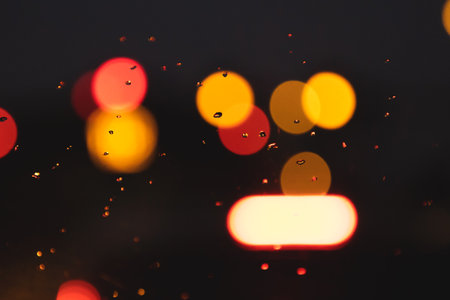 Multicolored cityscape evening background with blurred traffic light circles, bokeh. For backgroundの写真素材