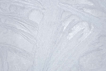 Ice patterns frost on the window. clean blue background. beautiful texture of nature.の写真素材