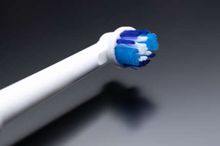 Electric toothbrush on a dark background, replaceable tips on the toothbrushの写真素材