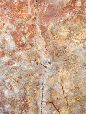 Texture of old cracked paint on the wall. Old vintage pattern of painted concrete wall. orange and yellow colorの写真素材
