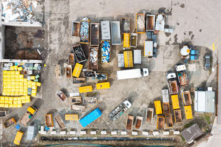 A lot of containers for collecting city garbage, sorting and processing garbage, a garbage truck for transporting and collecting garbage. View from aboveの写真素材