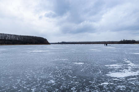 Frozen river, river covered with ice in frost, winter landscapeの写真素材