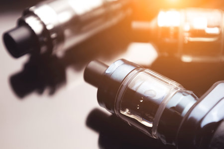 e-cigarettes. A lot of electronic cigarettes on a black background, devices for vaping nicotine,...