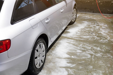 Car wash, a lot of active foam on the car and on the groundの写真素材