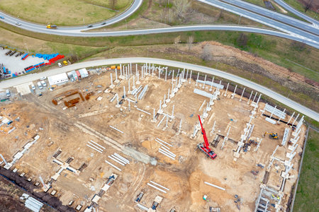 Construction of a large logistics warehouse, top view of the construction site, with concrete blocks...