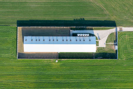 View from a height of a large livestock farm. Outbuildings, big houses in the fieldの写真素材