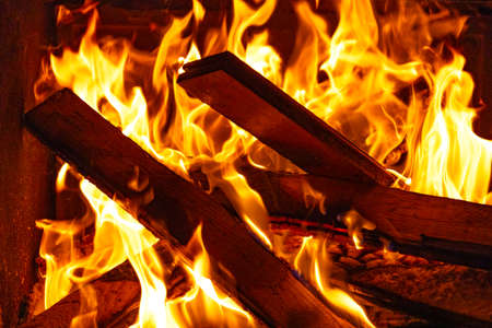 Burning wood in the fireplace, bright red fireの写真素材
