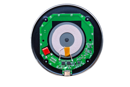 wireless phone charger. Disassembled broken wireless charger isolated on white background
