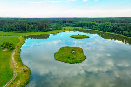 Beautiful view of the lake in the forest, small islands for relaxing on the lake, summer landscapeの写真素材
