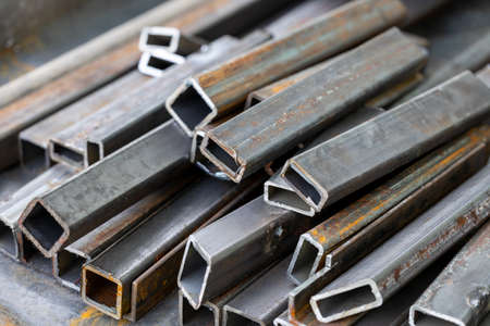 A lot of metal profile pipes stand on a pileの写真素材