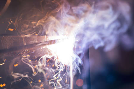 A bright flash of an electric arc between the electrode and the metal. arc weldingの写真素材