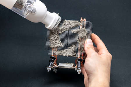 Computer master cleans the radiator of the computer cooling system, computer repairの写真素材