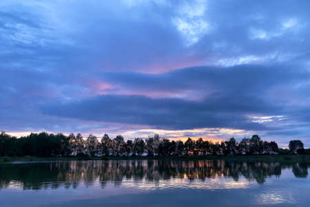 By the lake in the evening at sunsetの写真素材