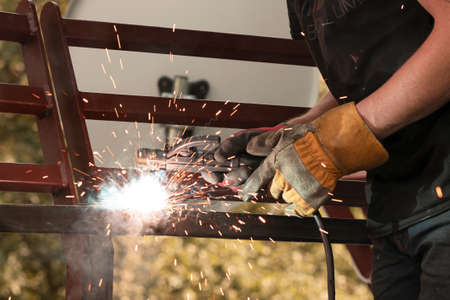 Welder welds metal by arc welding, welding of metal structuresの写真素材