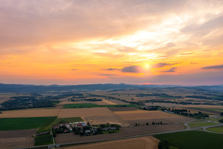 Beautiful golden sunset over wheat field, rural scene, top viewの写真素材