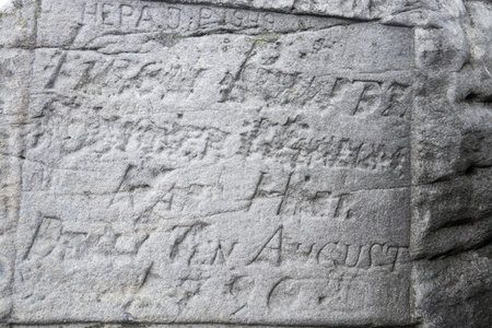 Old carved inscription on the rock, inscription on the rock