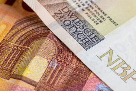Close-up of euro and zloty banknotes, euro to polish zloty exchange rate