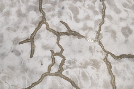 Many cracks in the concrete floor, restoration of a concrete floor in an industrial building