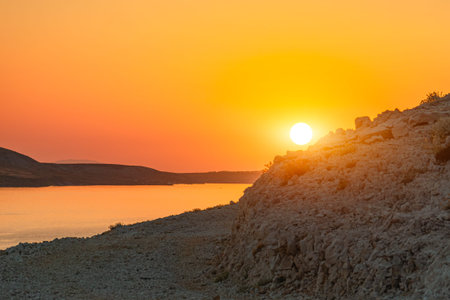 Beautiful sunset colors over the mountains on the island of Pag, Croatia. Empty islands in the...