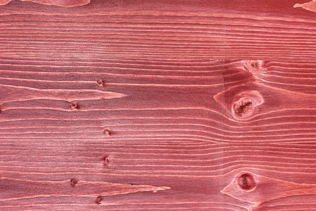 Red board close-up, wood texture, knots and fibersの写真素材