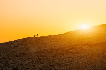 People at sunset go into the distance, summer sunset in the mountainsの写真素材