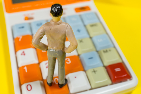 Men stand on the calculatorの写真素材