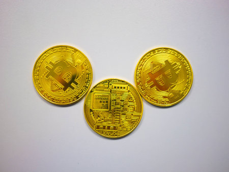three bitcoins on white background