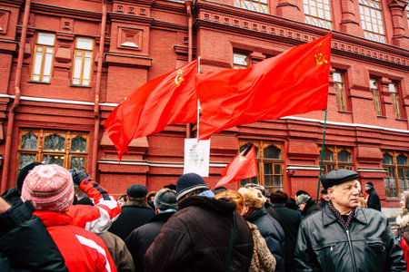 Red flag flutte in front of historical museum on Manezhnaya Square. Communist demonstration