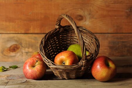 Still life with pear and red apples in a basketの写真素材
