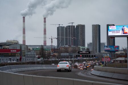 Road traffic, construction of residential houses and Smoking pipes in Moscowの写真素材