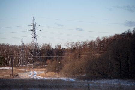Russian winter landscape with forest and power lines.の写真素材