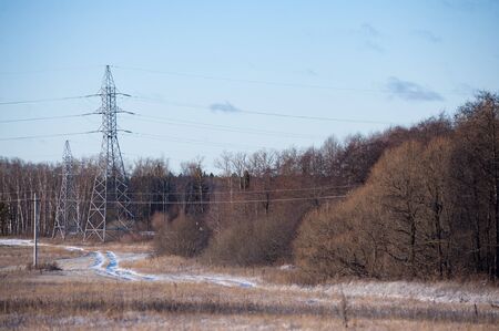 Russian winter landscape with forest and power lines.の写真素材