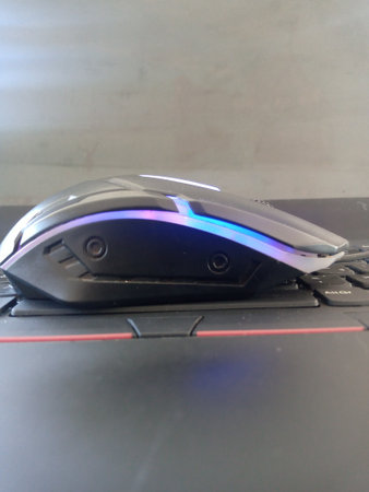 Computer mouse on a black computer keyboard. Selective focus on the mouse.の写真素材