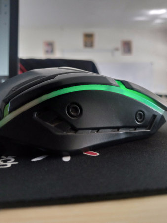 Wireless computer mouse on a black table in a modern office.の写真素材