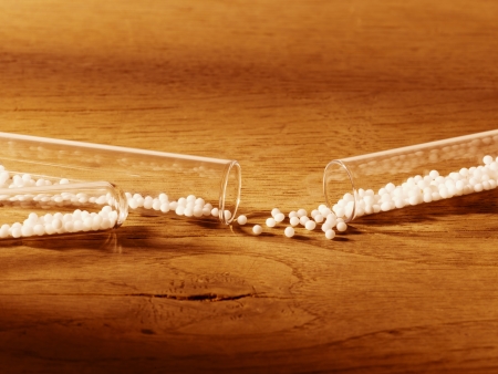 Globules in a test tube on wooden tableの写真素材