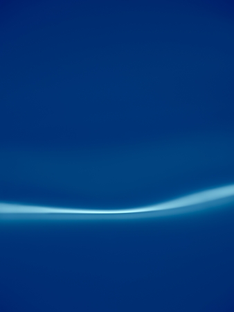 Blue background with white line of lightの写真素材