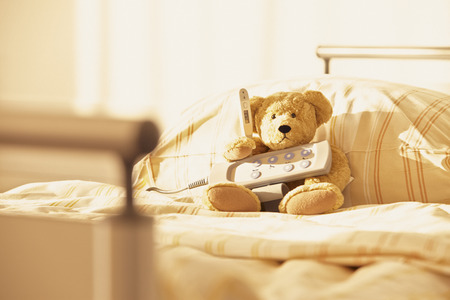 Room with bed and teddy bear in hospitalの写真素材